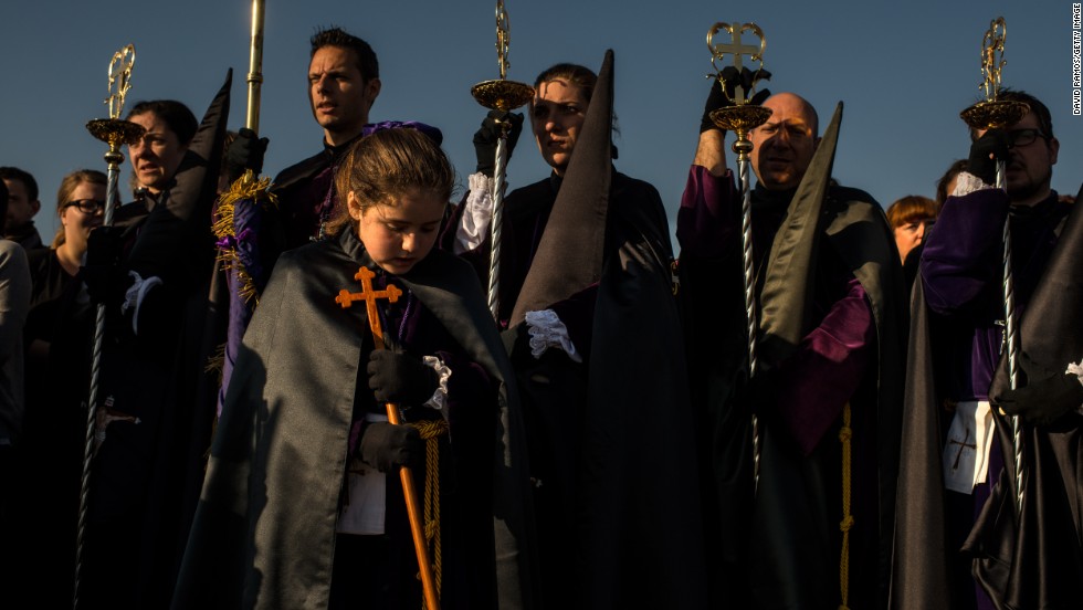 Worshippers of the Santisimo Cristo del Salvador brotherhood pray around the crucifix during a procession April 18 in Valencia, Spain. 