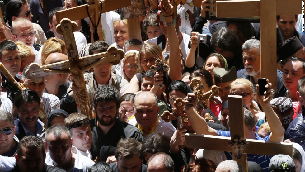 Christian Orthodox pilgrims carry wooden crosses during a Good Friday procession in Jerusalem.