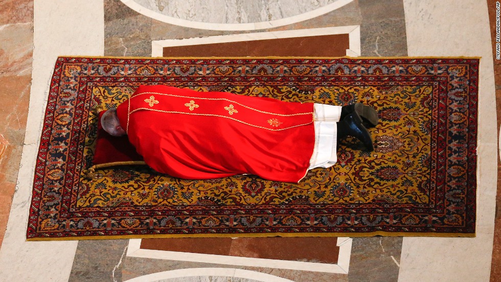 Pope Francis lies on the floor in prayer before presiding over a Good Friday service in St. Peter&#39;s Basilica.