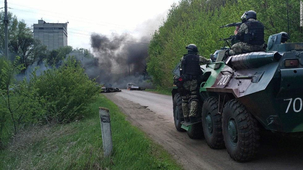 Ukrainian troops take position near burning tires at a pro-Russian checkpoint in Slovyansk on Thursday, April 24. 