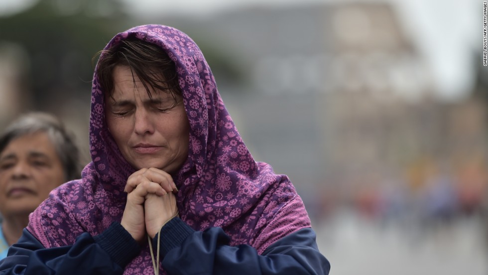 A woman prays during the canonization Mass for Popes John XXIII and John Paul II on April 27.