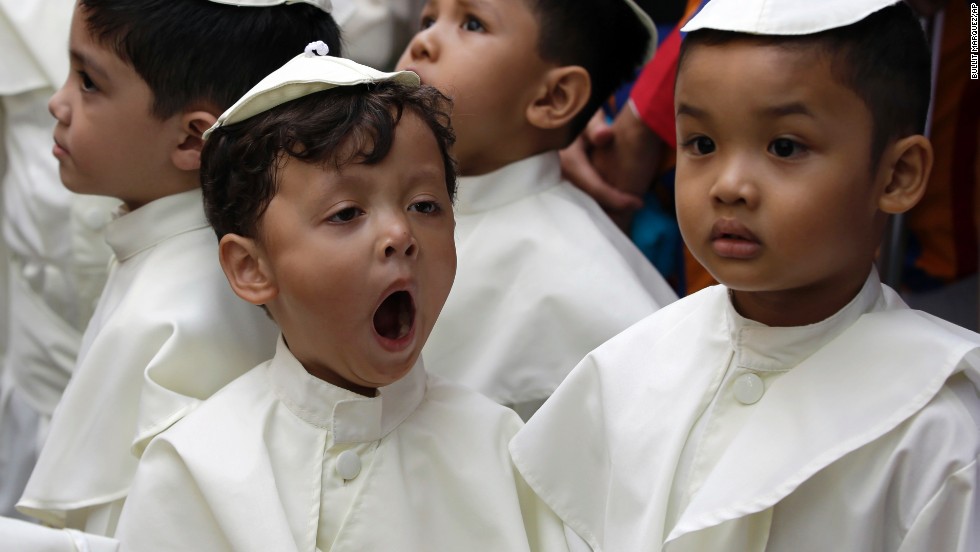 A boy dressed as a pope yawns as he joins a parade in Quezon, Philippines, on April 27 in celebration of the canonization of Pope John Paul II and Pope John XXIII.