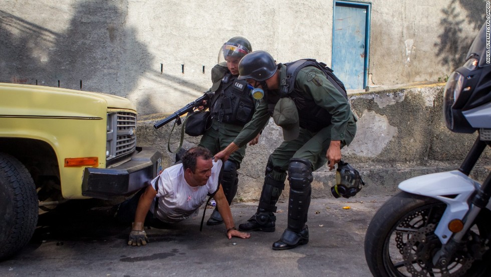 Members of the Venezuelan National Guard detain a man during a protest against the government of President Nicolas Maduro in Caracas, Venezuela, on Saturday, April 26. Over several months, protesters unhappy with Venezuela&#39;s economy and rising crime have squared off against security forces.
