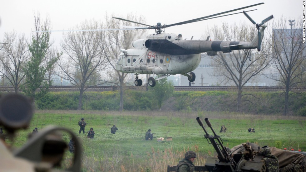 Ukrainian soldiers arrive to reinforce a checkpoint that troops seized Friday, May 2, in Andreevka, a village near Slovyansk. Two helicopters were downed Friday as Ukrainian security forces tried to dislodge pro-Russian separatists from Slovyansk, Ukraine&#39;s Defense Ministry said.