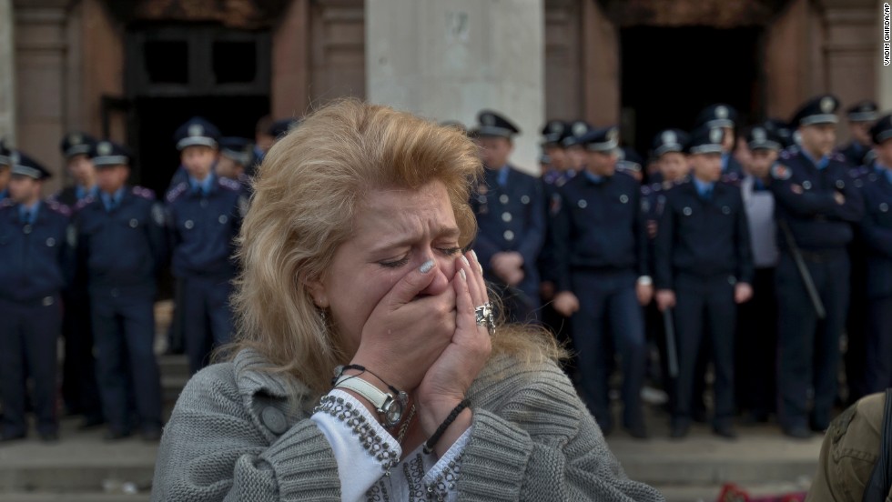 A woman cries in front of the burned trade union building in Odessa on May 3.