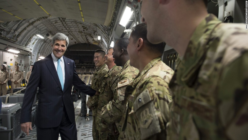 Kerry talks with the crew of a U.S. Air Force plane prior to departure from Addis Ababa, Ethiopia, on Friday, May 2,  2014. He was en route to Juba, South Sudan, to demand a cease-fire in the brutal civil war that has sparked dire warnings of genocide and famine.
