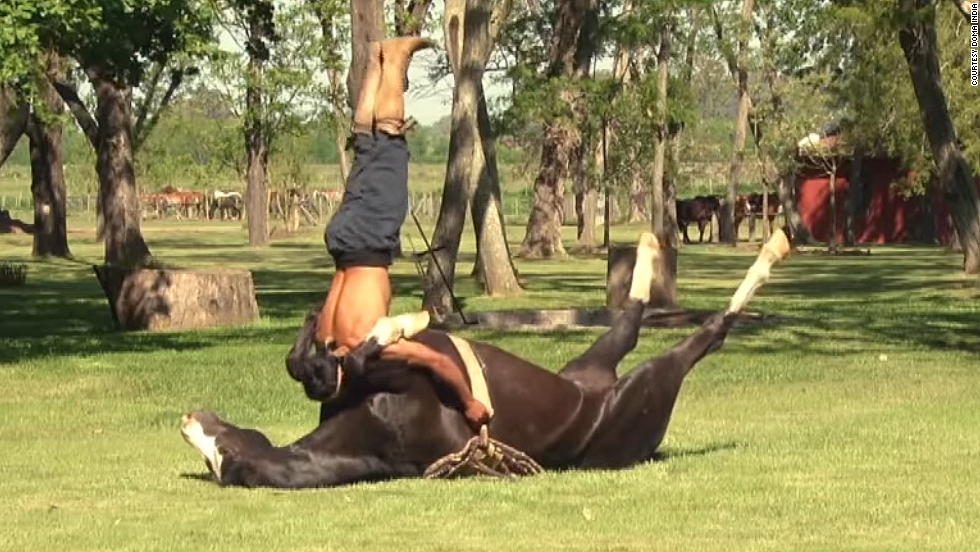 A wrangler performs yoga-esque poses atop a horse at the Doma India horse taming school in San Luis, Argentina.