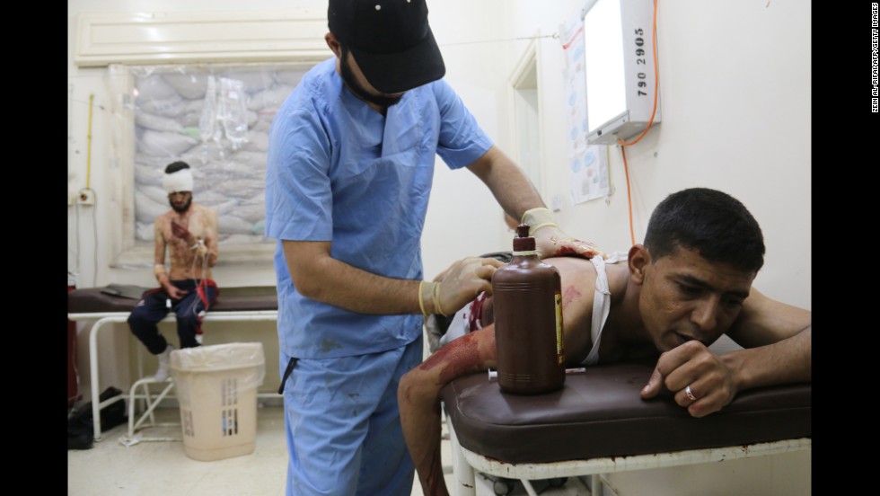 A wounded man is treated at a makeshift hospital in Aleppo on Sunday, May 4.