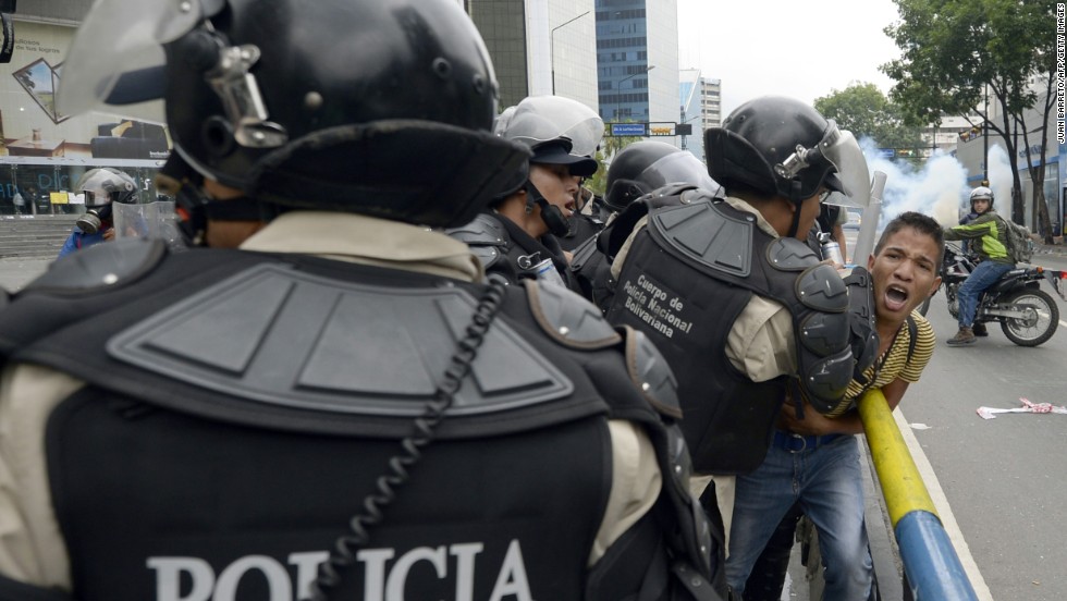 Venezuelan riot police arrest a student taking part in an anti-government protest in Caracas on May 8.