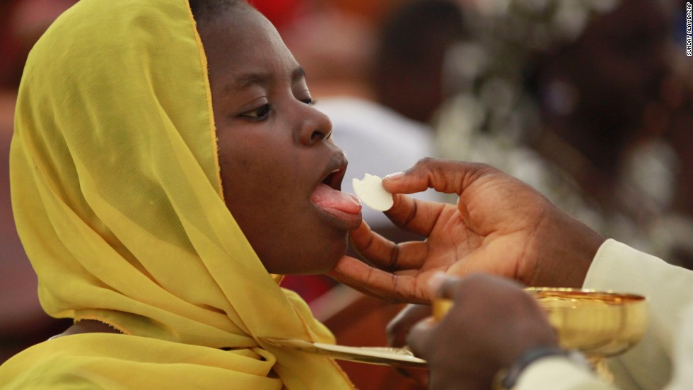 Catholic faithful in Abuja take Holy Communion and pray for the safety of the kidnapped schoolgirls on Sunday, May 11.