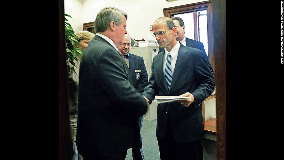 In May 2009, Maine state Sen. Dennis Damon, left, hands Gov. John Baldacci the bill that the state Senate passed to affirm the right of same-sex couples to marry.