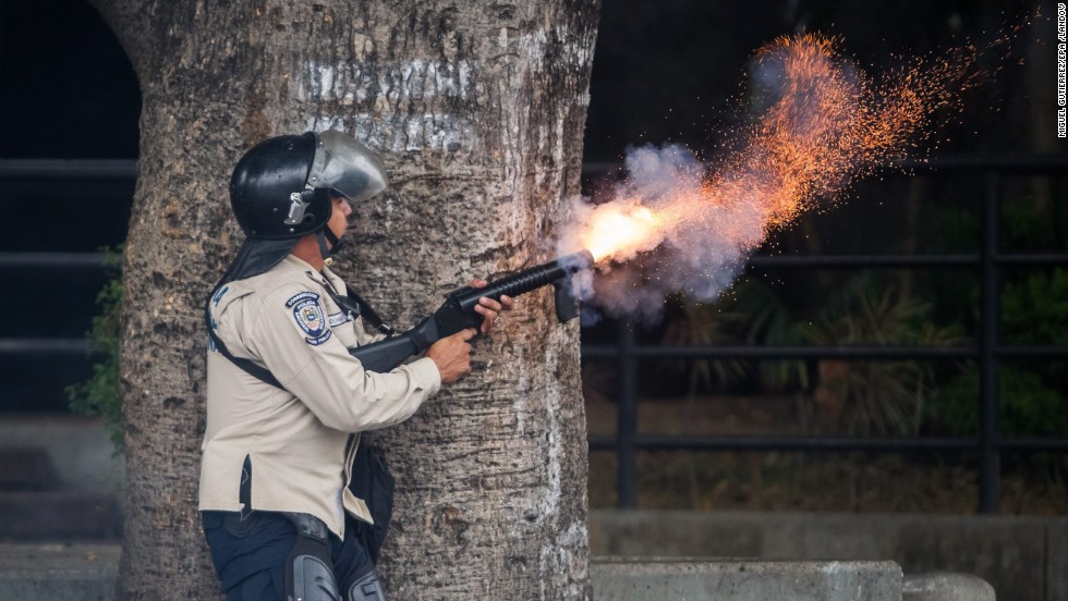 A member of the Bolivarian National Police clashes with protestors during a demonstration against Venezuelan President Nicolas Maduro in Caracas on Saturday, May 10. Clashes between anti-government protesters and security forces have left more than 40 people dead and about 800 injured since February, according to officials.