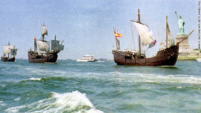 Replicas of Christopher Columbus&#39; ships, the Nina, Pinta and Santa Maria, sail past the Statue of Liberty.