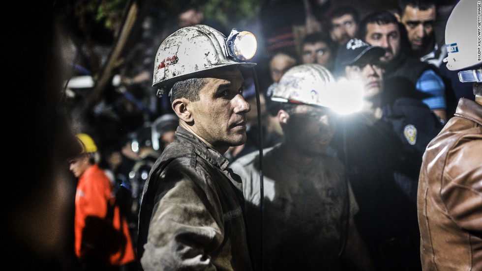 Miners stand by after the explosion. About 100 rescuers, dozens of ambulances and helicopters were dispatched to the scene.