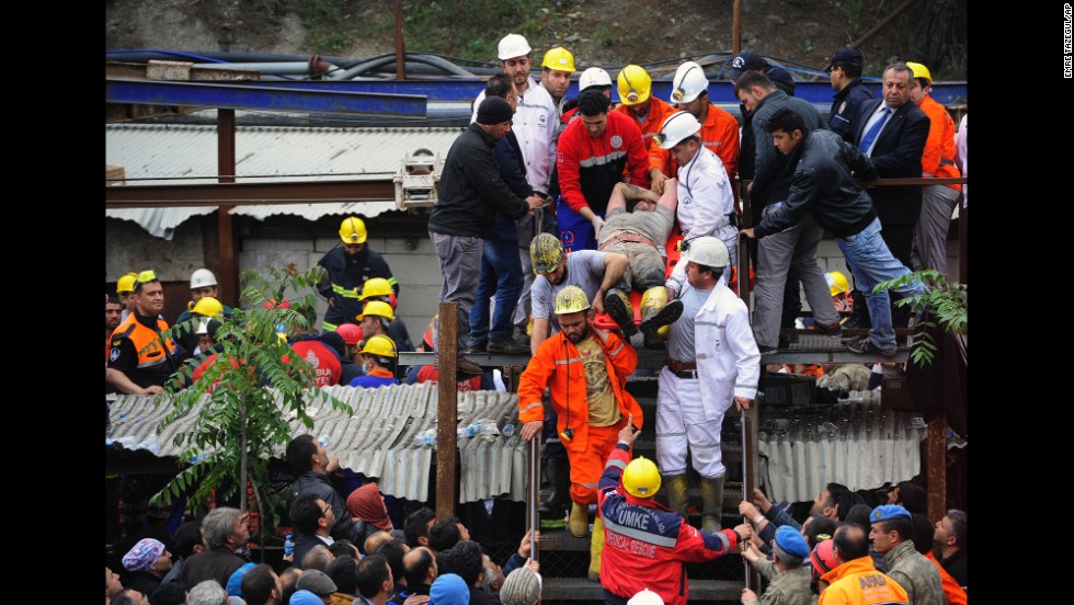 Rescue workers carry a miner to an ambulance on May 14.