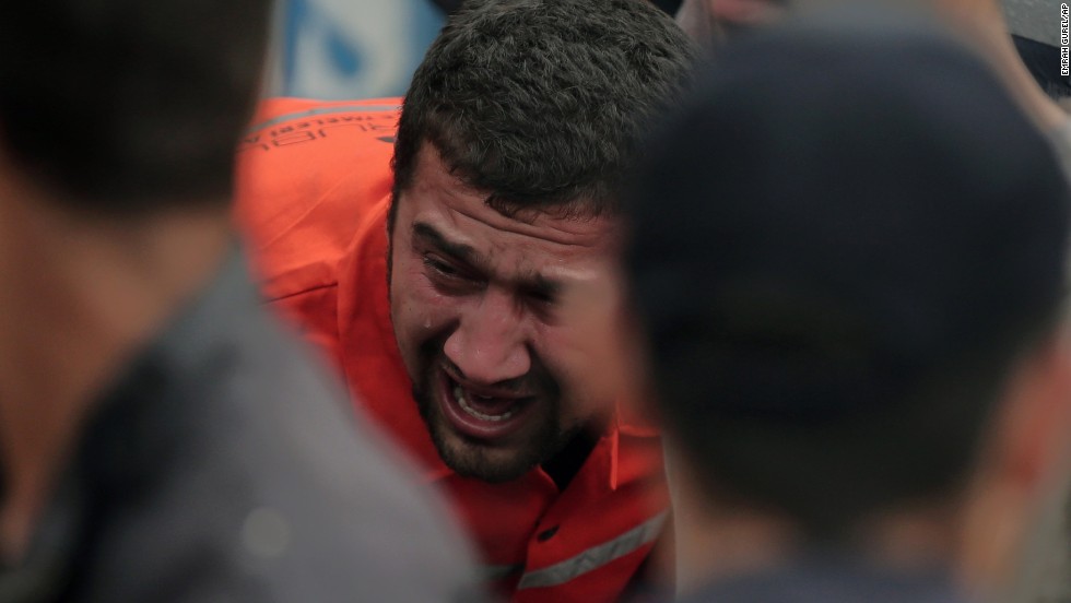 A family member cries as rescue workers carry a survivor from the mine on May 14.