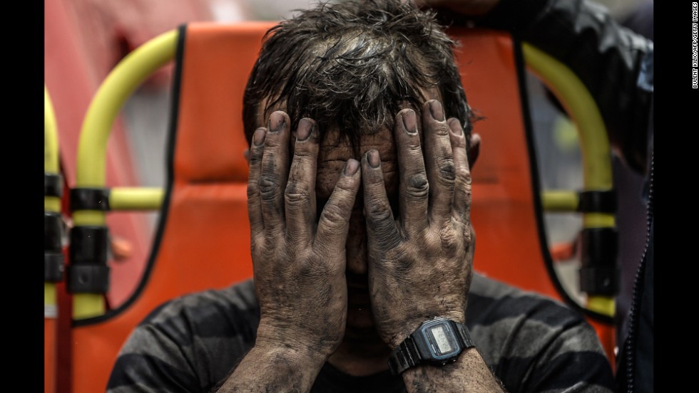 A miner covers his face after being affected by toxic gas during rescue operations on May 14.