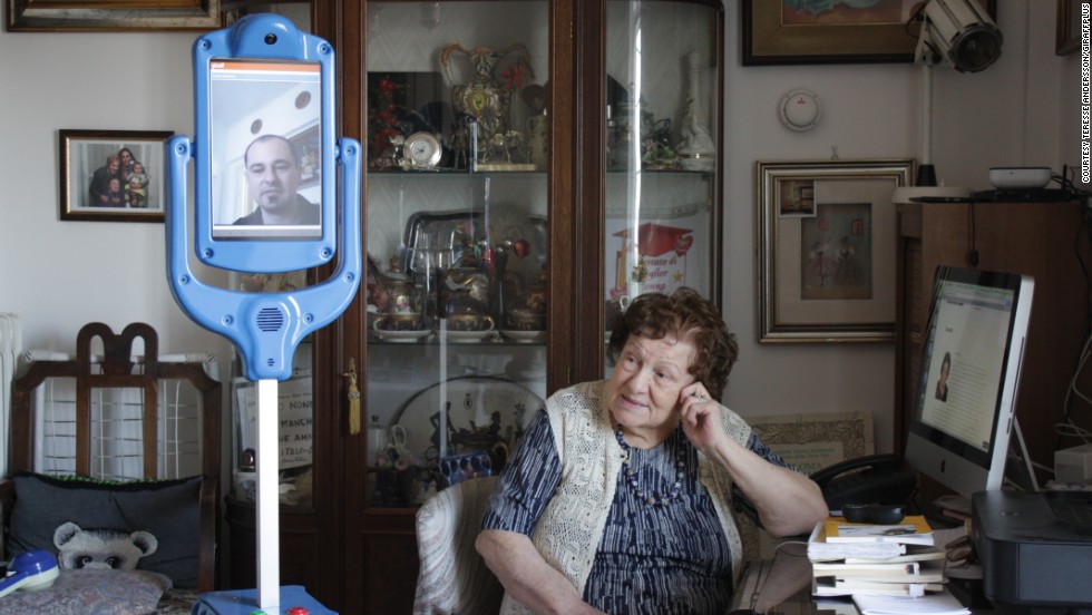 This Italian woman is being assisted by the Giraffplus robot carer at her Rome apartment. The Giraffplus is connected to sensors that measure indicators such as blood pressure and communicate with medical staff.