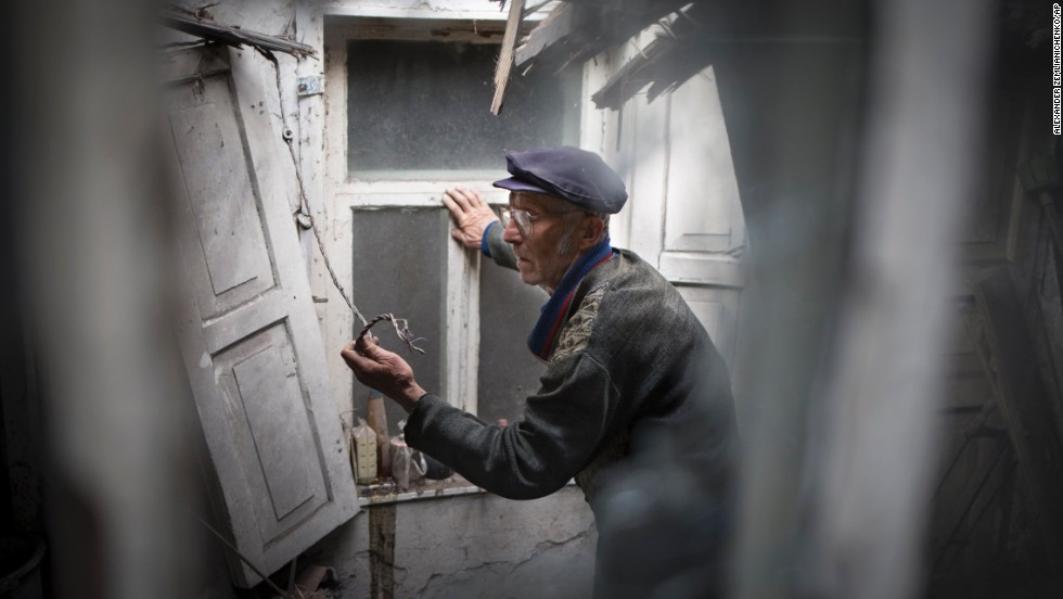 A man surveys the damage to his home after a mine exploded during an exchange of fire between pro-Russian militants and government troops outside Slovyansk on May 15.