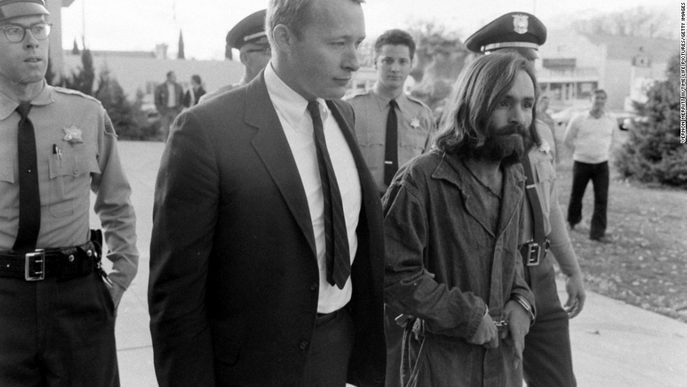 Cult leader Charles Manson is taken into court to face murder charges on December 5, 1969, in Los Angeles. At Manson&#39;s command, a small group of his most ardent followers brutally murdered five people at the Los Angeles home of film director Roman Polanski on August 8-9, 1969, including Polanski&#39;s pregnant wife, actress Sharon Tate. Manson was convicted for orchestrating the murders and sentenced to death. The sentence was later commuted to life in prison.