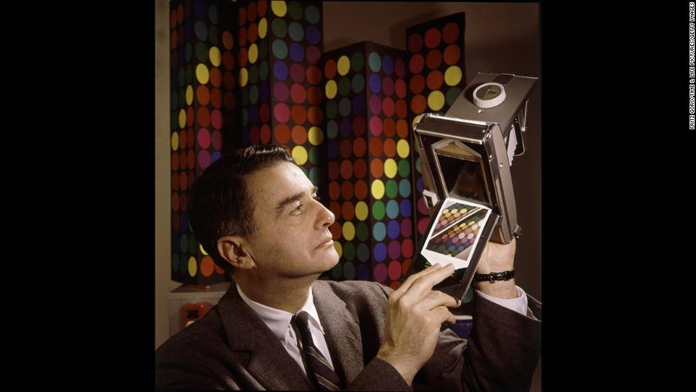 Inventor Edwin Land, president and co-founder of the Polaroid Corporation, demonstrates his company&#39;s new instant-color film in 1963.
