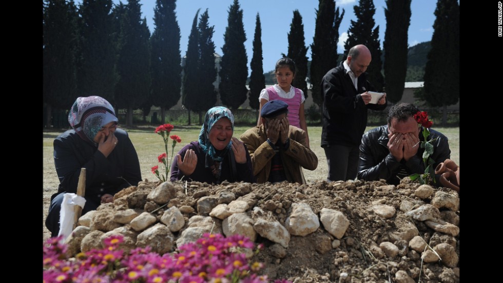 Family members mourn at the grave of a victim on May 16.