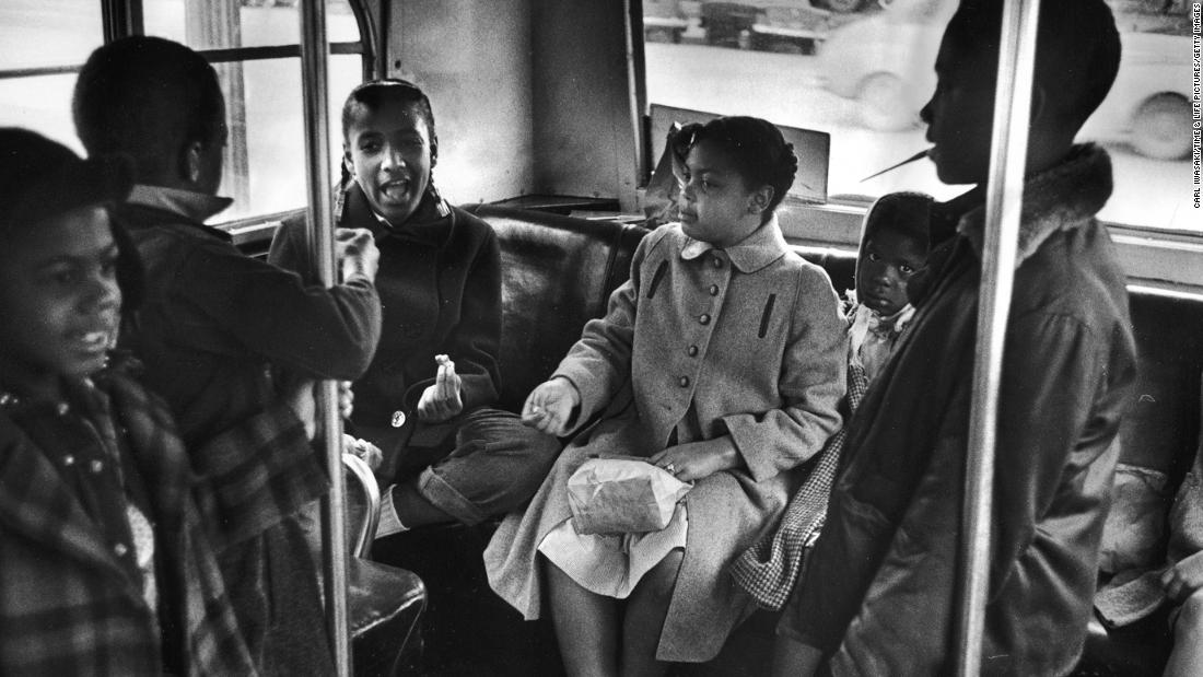 Linda Brown, center, and her sister Terry Lynn, far right, take a bus to Monroe Elementary School, an all-black school in Topeka, in 1953.