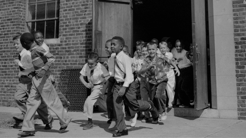 Fourth-graders, both black and white, dash for the playground at St. Martin School in Washington on September 17, 1954. The Supreme Court ruling did not set a schedule for the integration of schools, rather calling for &quot;deliberate speed.&quot; The District of Columbia and four states acted to end segregation promptly, while other areas met with resistance.