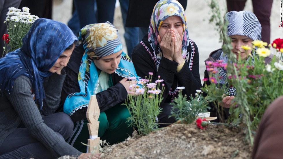 Friends and relatives of dead miners pray at a cemetery on Saturday, May 17.  The search for victims of this week&#39;s coal mine fire in Soma is now over, with a final death toll of 301, Turkish government officials said Saturday.