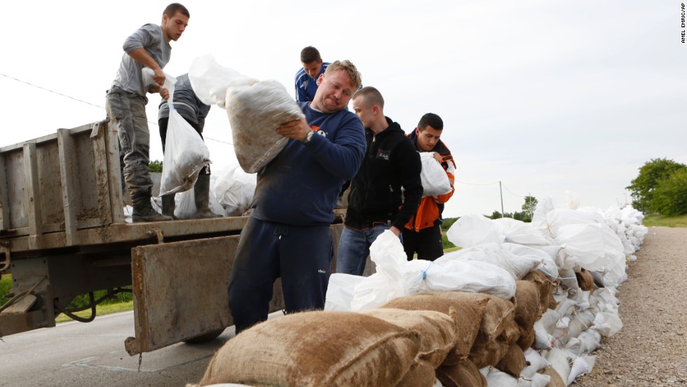 Residents place sandbags on a road near Orasje, Bosnia-Herzegovina, to protect the city from flooding on May 18.