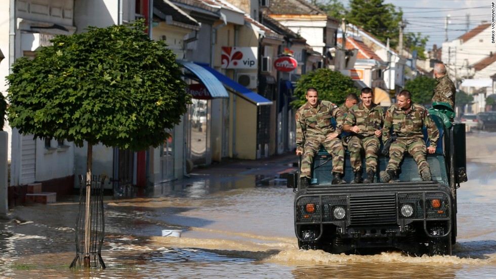 A police vehicle drives through a flooded street in Obrenovac on May 18.