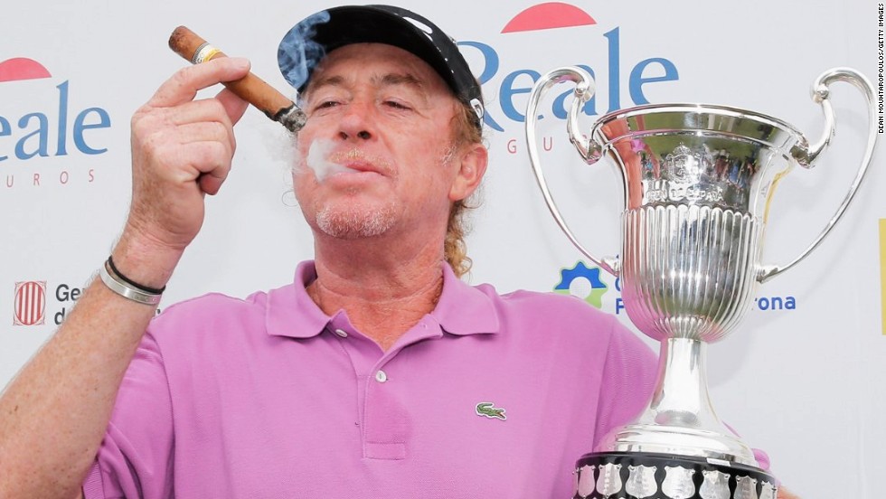 With his trademark victory cigar in one hand, Miguel Angel Jimenez poses with the trophy in the other after winning his home Spanish Open for the first time on May 18, 2014. Having passed 50, he is the European Tour&#39;s oldest victor.