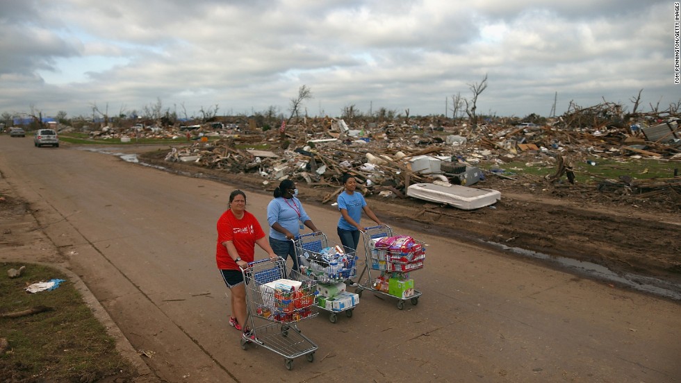 &lt;strong&gt;Then:&lt;/strong&gt; From left, Jaqi Castro, Angelica Morris-Smith and Cetoria Petties walk through a tornado-ravaged neighborhood handing out supplies to residents and fellow volunteers on May 27, 2013.