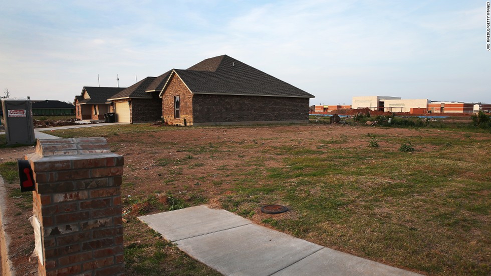 &lt;strong&gt;Now:&lt;/strong&gt; New homes stand beside empty lots in the neighborhood on May 18, 2014.