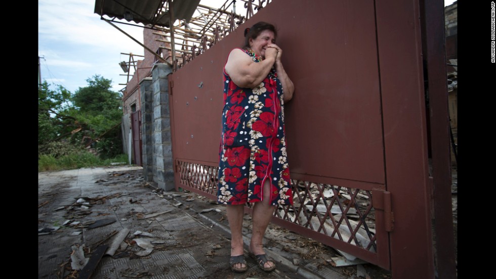 Yekaterina Len cries outside her home after it was hit by mortar shells during fighting between pro-Russian separatists and Ukrainian soldiers in Slovyansk on Tuesday, May 20. 