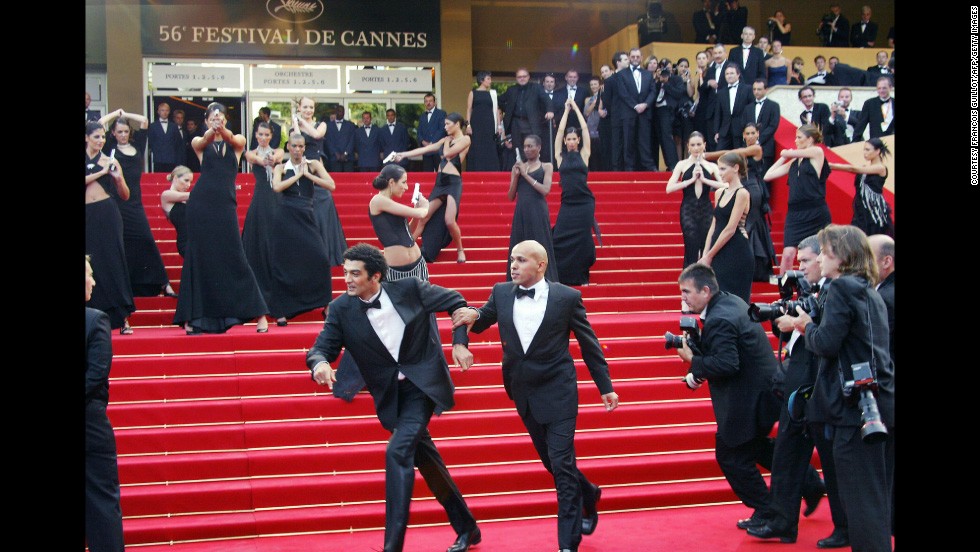 Being chased by paparazzi and shot at by Bond girls is just another day in the life of french humorist duo Erik et Ramzy. The pair joke with the Bond girls upon arrival at the Palais des festivals before the screening of the film &quot;La Petite Lili&quot; by French director Claude Miller during the Cannes film festival in 2003. 