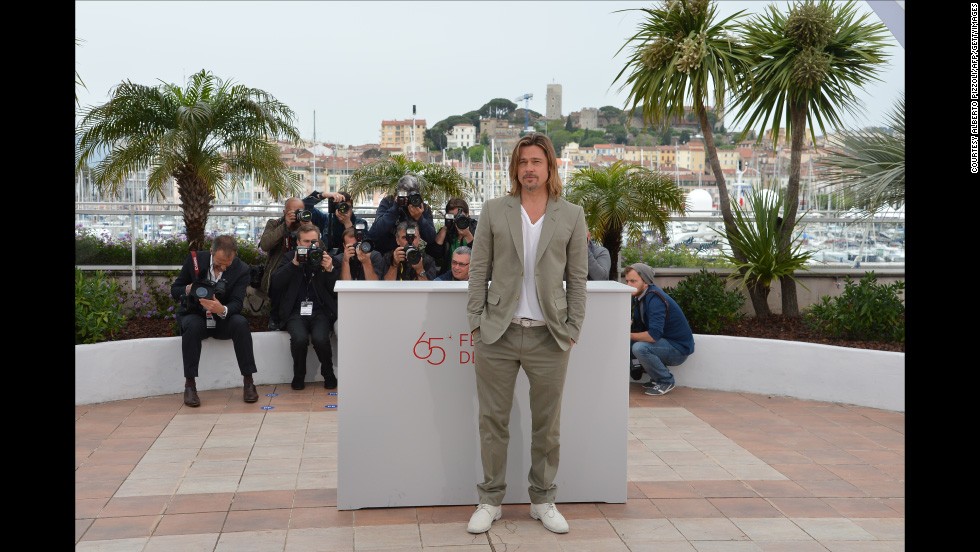 It is not immediately clear why this long blonde hair and white lace up look works, but it really, really does. Brad Pitt works the photo call for &quot;Killing Me Softly&quot; in Cannes, 2012.