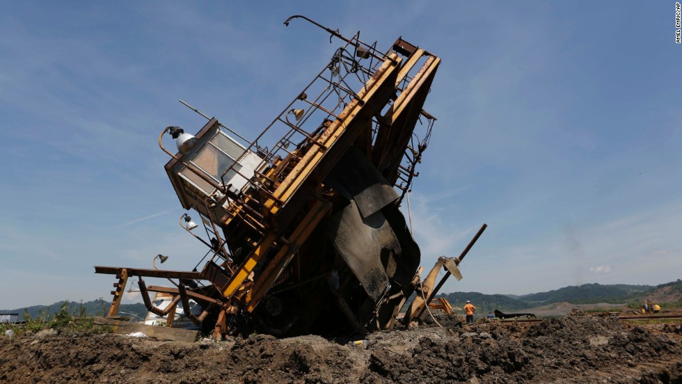Bosnian workers inspect the damage on heavy machinery after devastating flooding at a coal mine in the village of Sikulje on Thursday, May 22. Heavy rainfall in Serbia and neighboring Bosnia-Herzegovina has resulted in the worst flooding since records began 120 years ago, meteorologists say.