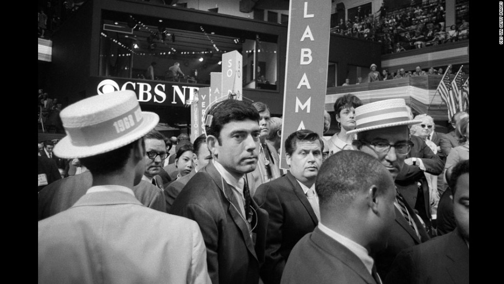 The 1968 Democratic Convention, held in Chicago, was a scene of chaos both inside and outside the convention hall. At one point, CBS correspondent Dan Rather, center, was treated roughly by security, prompting anchor Cronkite to comment, &quot;I think we&#39;ve got a bunch of thugs here, Dan.&quot; Outside, protesters chanted, &quot;The whole world is watching.&quot; 