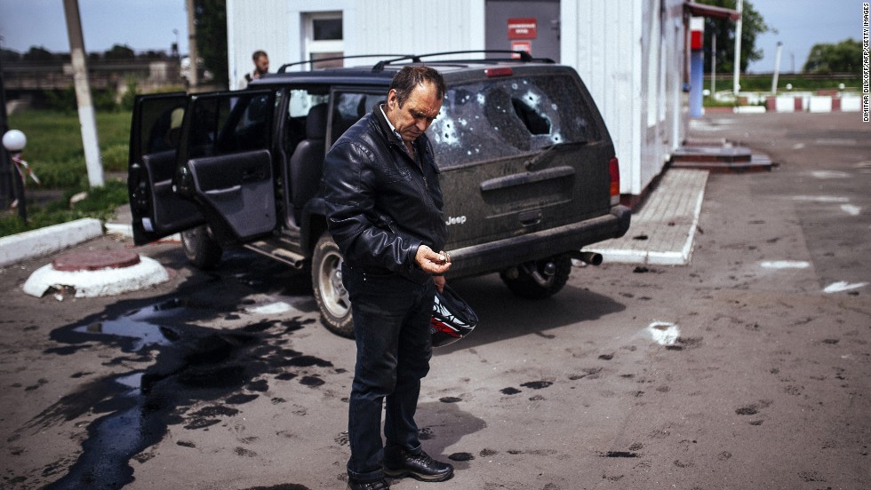 A man looks at a bullet shell next to a destroyed car after a gunfight between pro-Russian militiamen and Ukrainian forces in Karlivka, Ukraine, on Friday, May 23. Much of Ukraine&#39;s unrest has been centered in the Donetsk and Luhansk regions, where separatists have claimed independence from the government in Kiev.