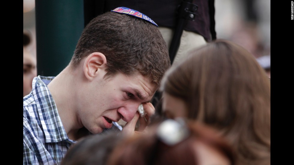 A man wipes away tears during a vigil in front of the museum on May 25.