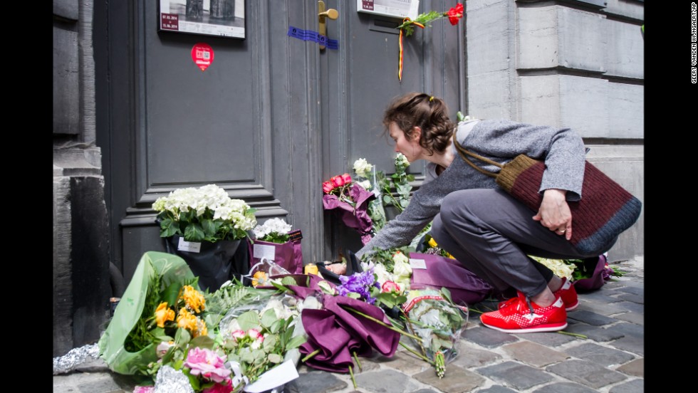 A woman lays flowers at the museum entrance on May 25.