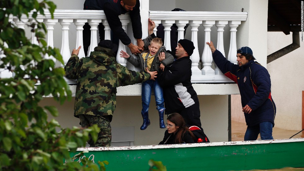 Serbian soldiers rescue a boy from a flooded house in Obrenovac on May 17.