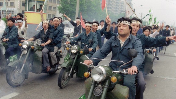 May 18, 1989, Chinese workers parade on motorbikes in support of student hunger strikers. 