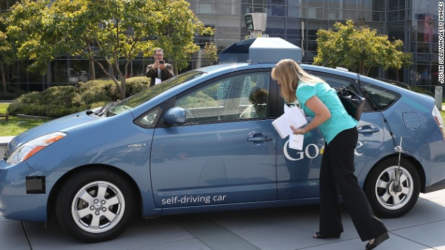 MOUNTAIN VIEW, CA - SEPTEMBER 25: A reporter looks at a Google self-driving car at the Google headquarters on September 25, 2012 in Mountain View, California. California Gov. Jerry Brown signed State Senate Bill 1298 that allows driverless cars to operate on public roads for testing purposes. The bill also calls for the Department of Motor Vehicles to adopt regulations that govern licensing, bonding, testing and operation of the driverless vehicles before January 2015. (Photo by Justin Sullivan/Getty Images)