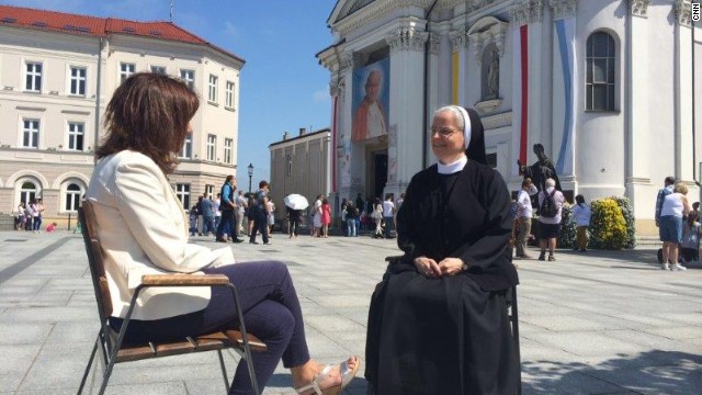 Paula Newton and Sister Benedykta Mazur sit outside Wadowice Basilica