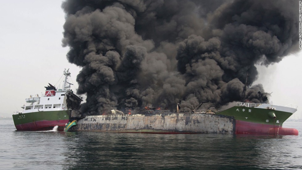 Clouds of black smoke billow from a Japanese oil tanker after it exploded.