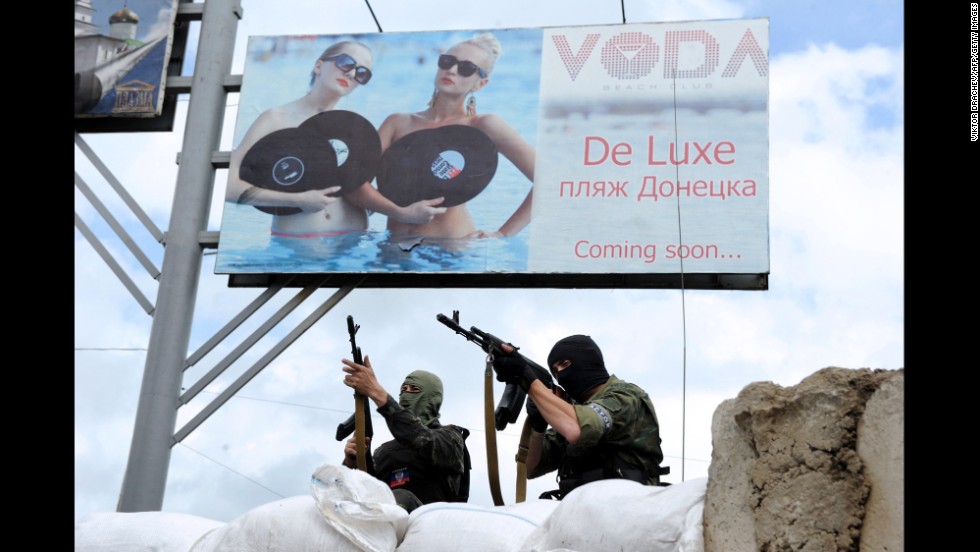 Pro-Russian militants stand guard at a barricade and checkpoint in Donetsk on Sunday, June 1.