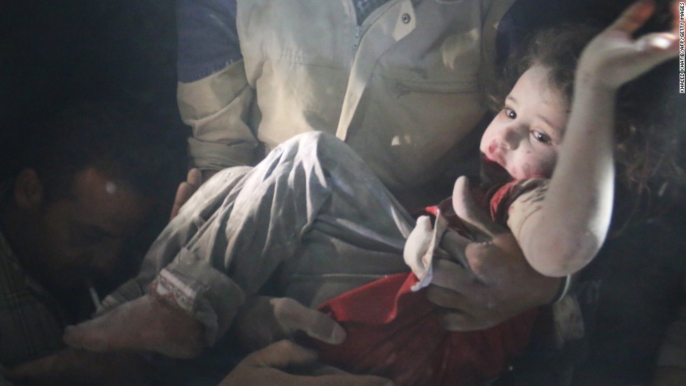 A rescue worker pulls a girl from rubble in Aleppo on June 1 after reported bombing by government forces.