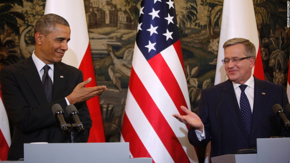 Obama and Komorowski gesture toward each other at a news conference in Warsaw on Tuesday, June 3.